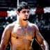 Shirtless male athlete with short dark hair standing outdoors, looking to the side. - Olive Oil Times