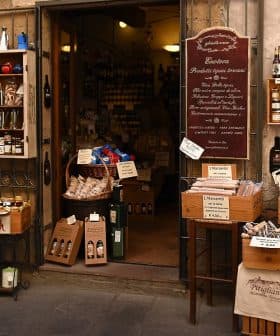 Entrance of an Italian specialty food store with various products displayed outside. - Olive Oil Times