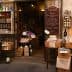 Entrance of an Italian specialty food store with various products displayed outside. - Olive Oil Times
