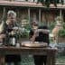 Two men participating in an olive oil tasting session at a wooden table outdoors. - Olive Oil Times
