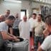A group of individuals observing a demonstration of the olive oil production process in a facility. - Olive Oil Times
