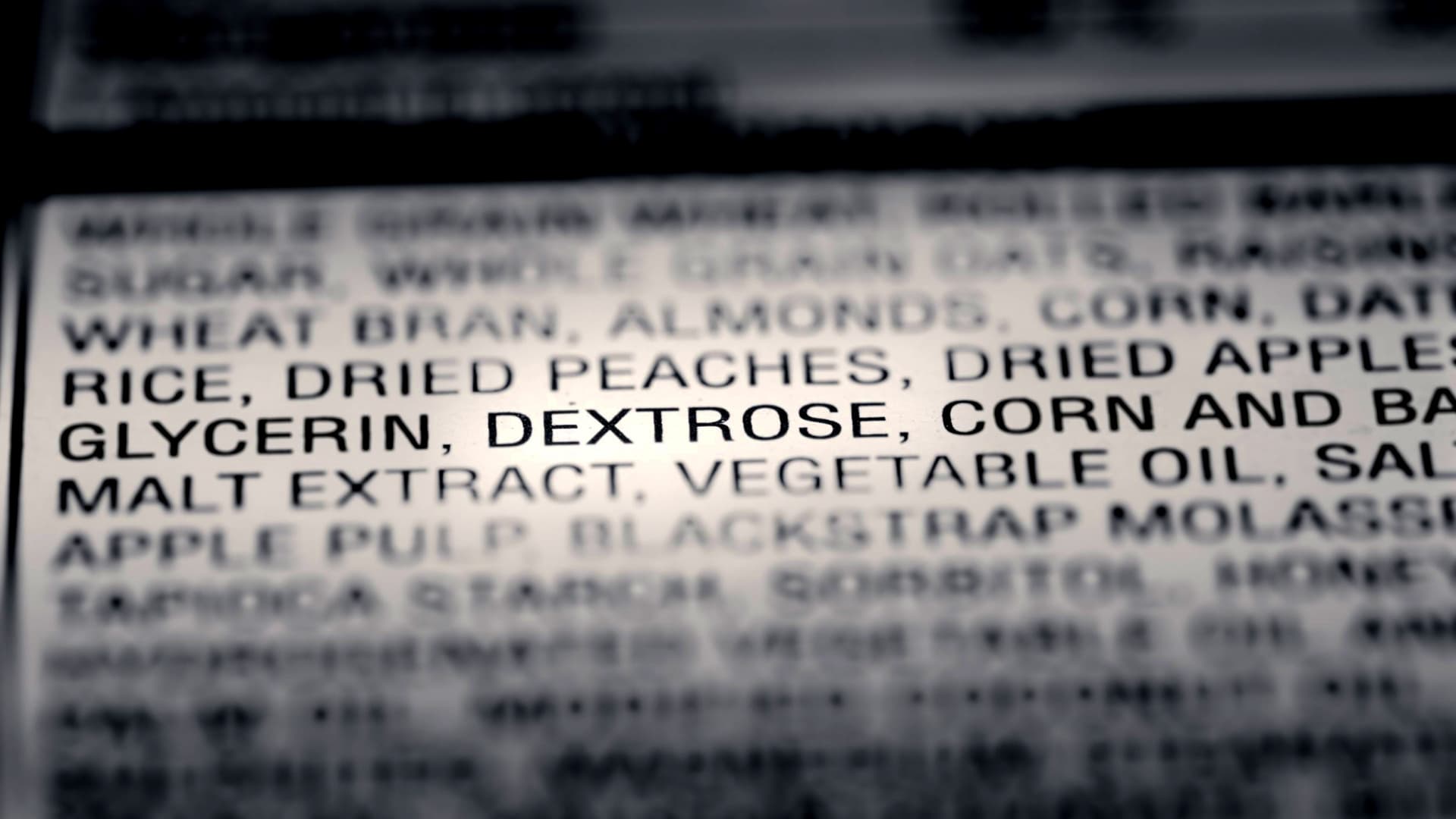 Close-up of an ingredient list on food packaging showing various components including dried fruits and glycerin. - Olive Oil Times