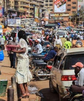 Crowded street in Kampala with pedestrians and vehicles, showcasing daily urban life. - Olive Oil Times