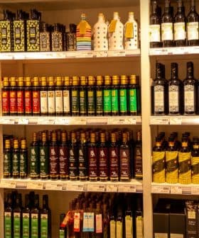 Shelves displaying a variety of olive oil bottles in different shapes and sizes. - Olive Oil Times