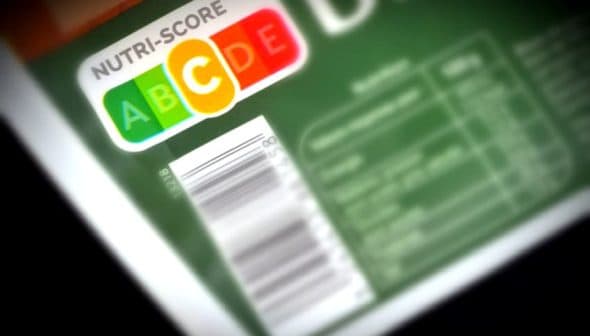 Nutri-Score label displaying letters A, B, C, D, E on food packaging with a barcode. - Olive Oil Times
