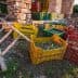 Various colorful crates filled with harvested olives placed near a stone structure. - Olive Oil Times