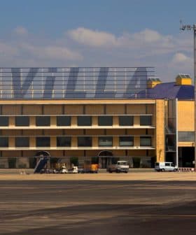 Sevilla airport building with the word 'SEVILLA' displayed prominently and a Ryanair airplane wing in the foreground. - Olive Oil Times