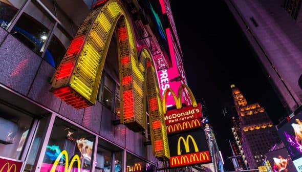 Illuminated McDonald's restaurant signage featuring the iconic golden arches at night. - Olive Oil Times