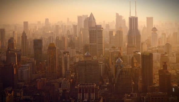A panoramic view of Shanghai's skyline with skyscrapers during sunset. - Olive Oil Times