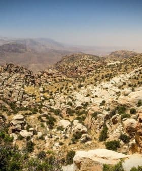 A rocky mountain landscape featuring rugged terrain and sparse vegetation under a clear sky. - Olive Oil Times
