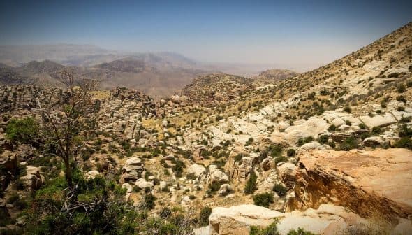A rocky mountain landscape featuring rugged terrain and sparse vegetation under a clear sky. - Olive Oil Times