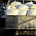 Pickup truck with a bed full of white bags on a street. - Olive Oil Times