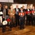 A group of individuals posing with awards during a ceremony, featuring various trophies and certificates. - Olive Oil Times