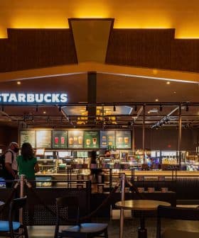 Interior view of a Starbucks coffee shop with a counter and seating area. - Olive Oil Times