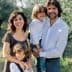 A family of four posing together in an olive grove, with two adults and two children. - Olive Oil Times