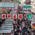 A busy street market in Hong Kong filled with numerous stalls and a large crowd of people. - Olive Oil Times