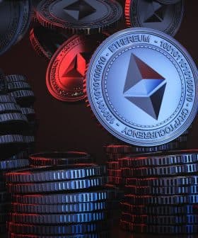 3D rendering of Ethereum coins stacked and floating in a dark background with red and blue lighting. - Olive Oil Times