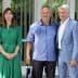 Three individuals standing together for a photo, with one woman in a green dress and two men in casual and formal attire. - Olive Oil Times