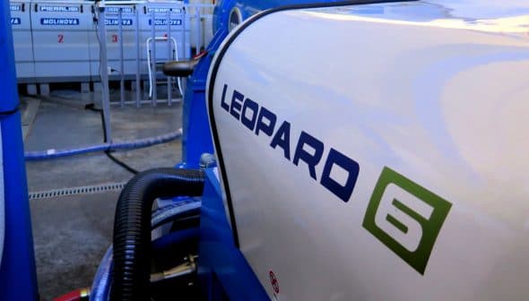 Close-up view of a Leopard 6 industrial machine with a blue and white design. - Olive Oil Times