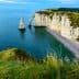 Cliffs and a prominent rock formation in the sea at Etretat, France, under a clear blue sky. - Olive Oil Times