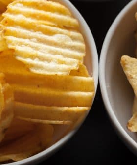Two bowls containing potato chips and tortilla chips arranged side by side. - Olive Oil Times