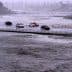 Vehicles cross over a flood control basin on Sunday, Aug. 20, 2023, in Palm Desert, Calif.