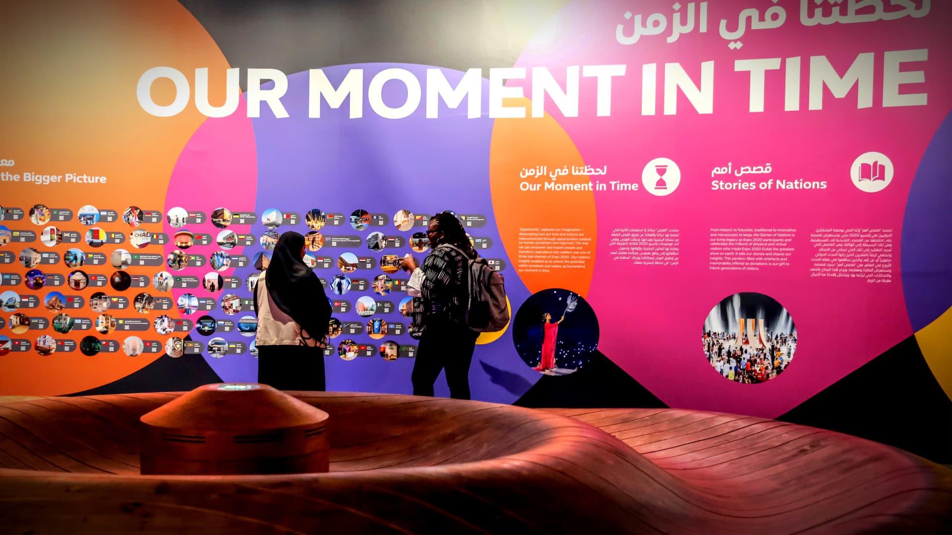 Colorful exhibition display featuring the phrase 'Our Moment in Time' and various images on the wall. - Olive Oil Times