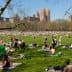 Large crowd of people enjoying a sunny day on the grass in Central Park, New York City. - Olive Oil Times
