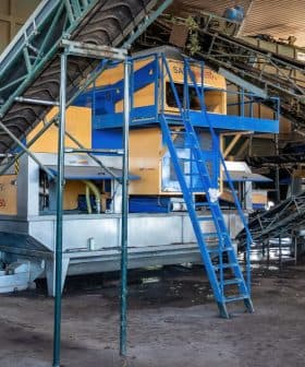 Industrial machinery used for processing olives in an olive oil production facility. - Olive Oil Times
