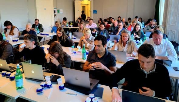 Participants seated at tables with laptops during a workshop session, focused on their tasks. - Olive Oil Times