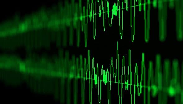 Digital representation of sound waves displayed in green on a dark background. - Olive Oil Times