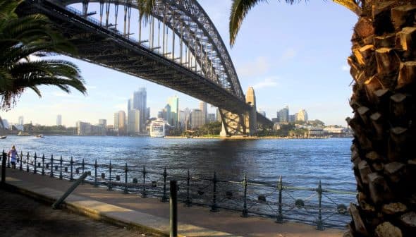 Sydney Harbour Bridge spanning over the water with the city skyline in the background. - Olive Oil Times