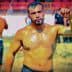 A male wrestler with a muscular build, wearing traditional oil wrestling attire, standing in a field. - Olive Oil Times