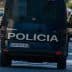 Rear view of a police van with the word 'Policia' on the back, driving on a city street. - Olive Oil Times