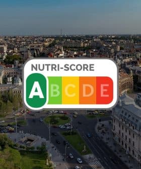 Aerial view of Bucharest cityscape with a Nutri-Score logo overlay in the center. - Olive Oil Times