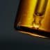 Close-up of an amber glass dropper bottle with a pipette top against a dark background. - Olive Oil Times