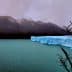 A glacier with a blue ice edge in a body of water, surrounded by mountains and a cloudy sky. - Olive Oil Times
