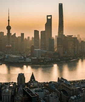 Aerial view of Shanghai's skyline with skyscrapers along the Huangpu River during sunset. - Olive Oil Times