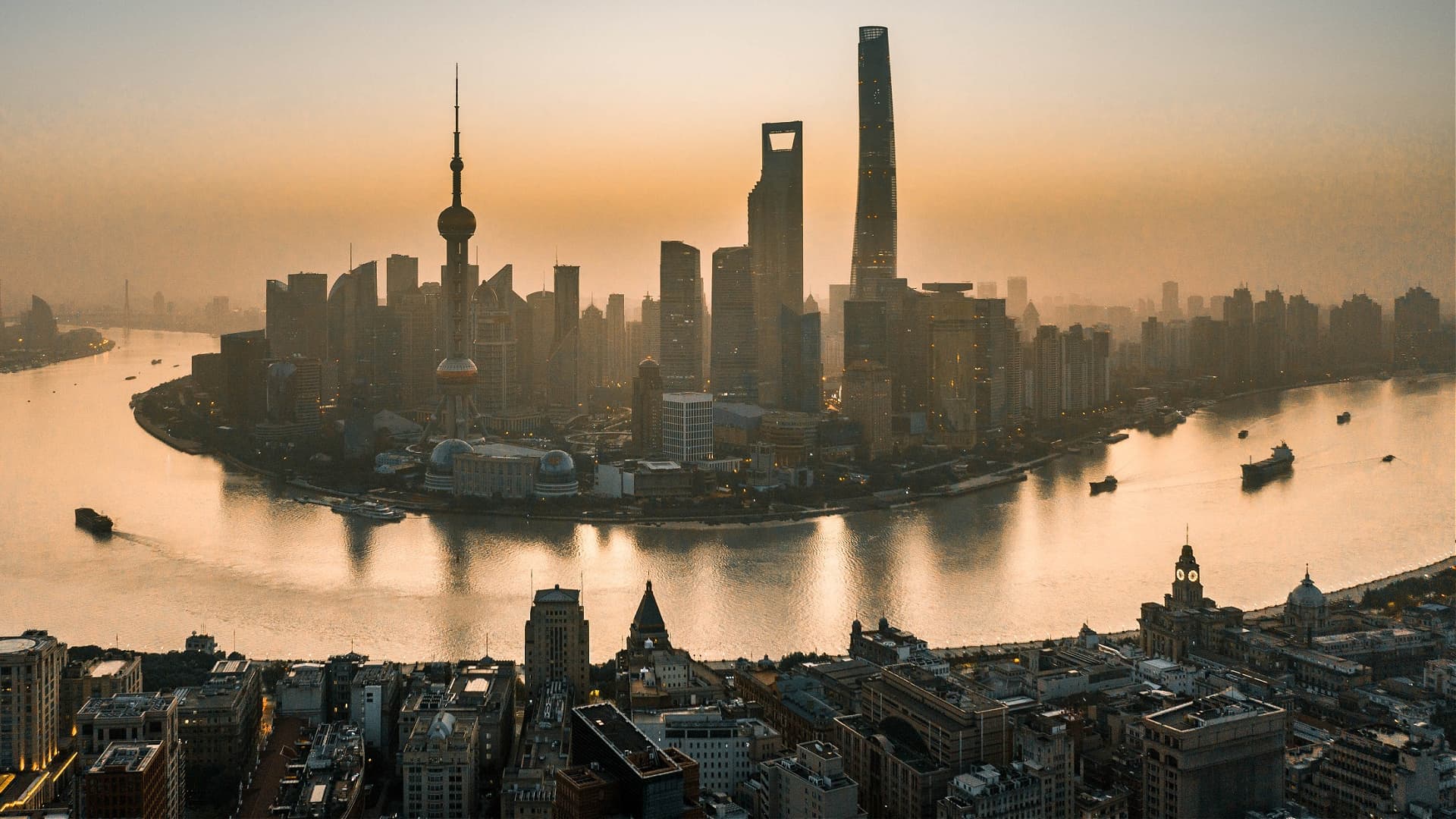 Aerial view of Shanghai's skyline with skyscrapers along the Huangpu River during sunset. - Olive Oil Times