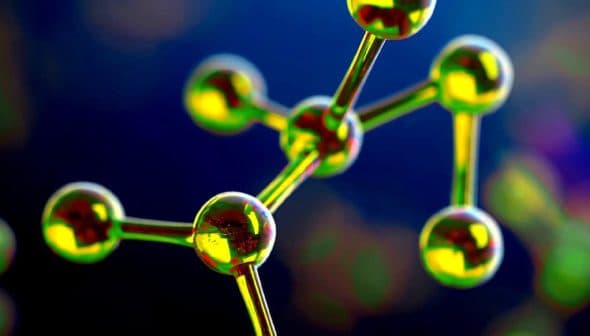 Close-up view of a molecular structure featuring green and yellow atoms connected by bonds. - Olive Oil Times