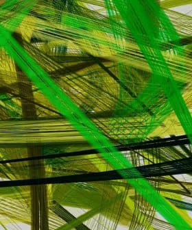 Abstract artwork featuring intersecting lines in green and yellow hues on a light background. - Olive Oil Times