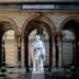 White statue of a historical figure located in the courtyard of the College de France building. - Olive Oil Times