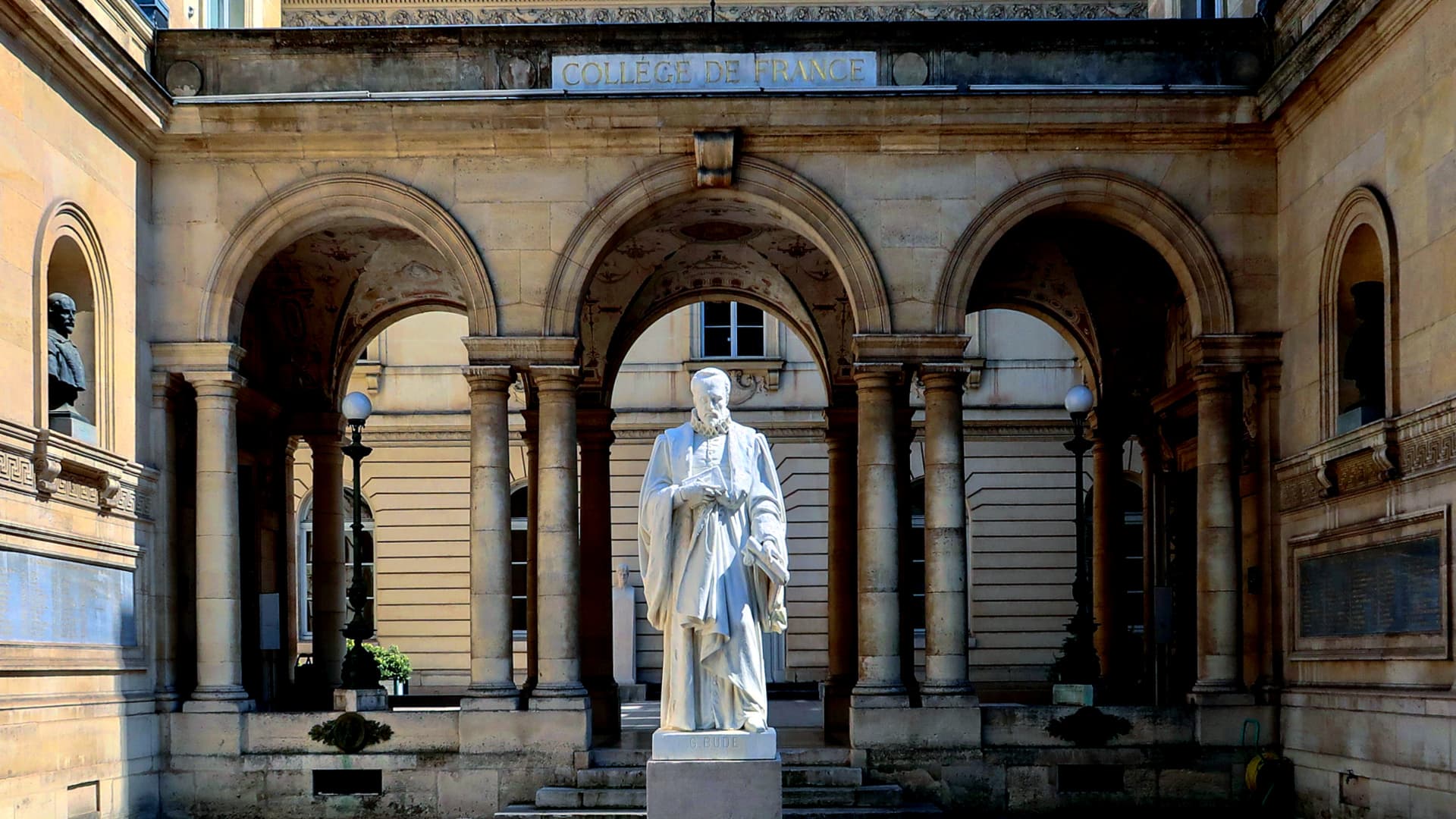 White statue of a historical figure located in the courtyard of the College de France building. - Olive Oil Times