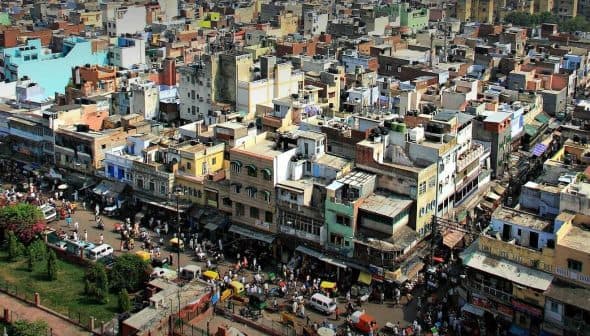 Aerial view of a densely populated urban area with various buildings and streets visible. - Olive Oil Times