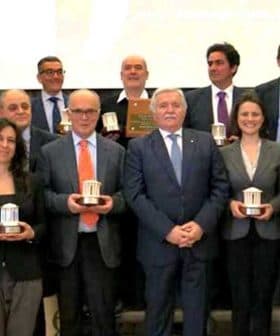 Group photo of winners holding awards at the 26th Ercole Olivario event. - Olive Oil Times